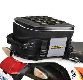 Nelson-Rigg beside helmet for scale showing compact 12L capacity benefit