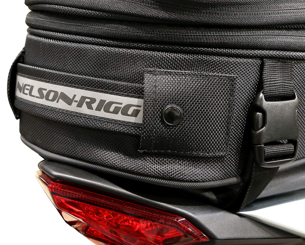 Nelson-Rigg mounted on a sport motorcycle tail demonstrating secure quick-release straps