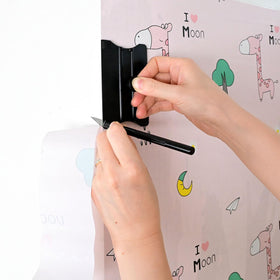 NEWISHTOOL next to ruler illustrating compact size and measurement accuracy