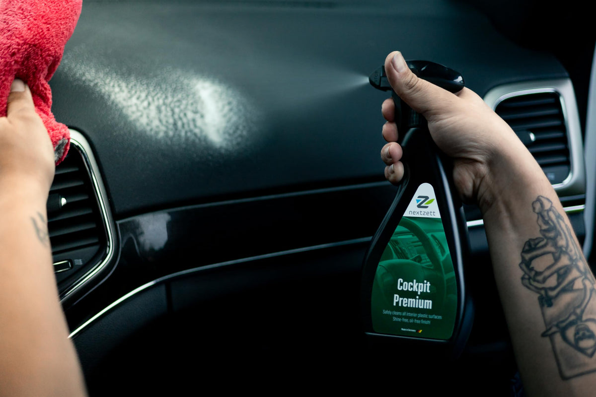 nextzett applying cleaner to dashboard demonstrating smear-free finish