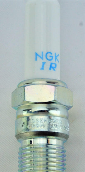 NGK on a mechanic workbench with tools demonstrating readiness for maintenance