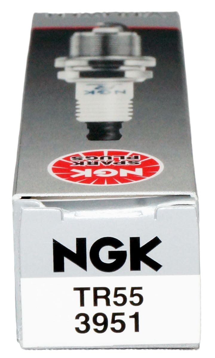 NGK spark plug in a garage setting illustrating professional installation