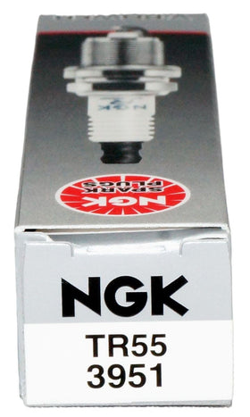 NGK spark plug in a garage setting illustrating professional installation