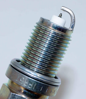 NGK spark plug installed in engine well demonstrating proper fit and performance