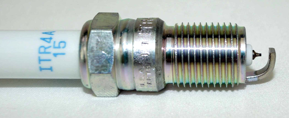 Open box showing eight NGK 5599 plugs emphasizing complete set and ready-for-service convenience