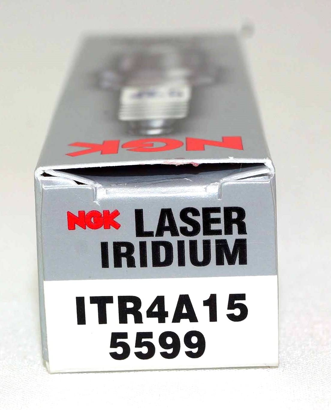 NGK plugs on garage workbench portraying DIY installation and dependable maintenance workflow