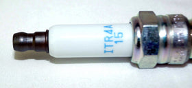 NGK spark plug next to ruler for scale to verify dimensions and correct replacement choice