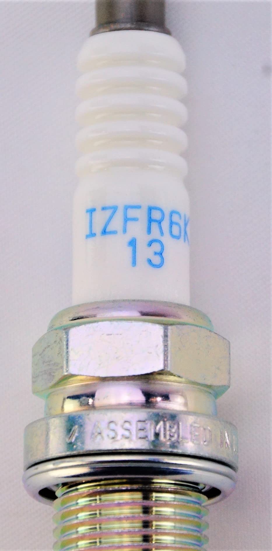 NGK size comparison beside ruler showing compact dimensions for fit verification