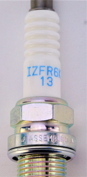 NGK size comparison beside ruler showing compact dimensions for fit verification