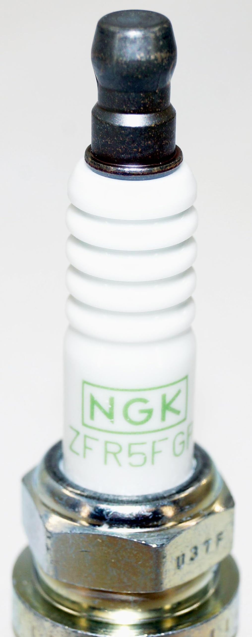 NGK plugs on workbench in garage lifestyle scene showing professional use