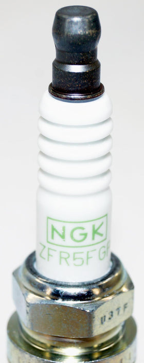NGK plugs on workbench in garage lifestyle scene showing professional use