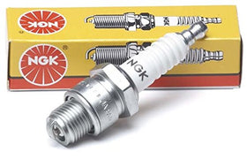 NGK BP8HS-15 four-pack next to ruler for scale and to confirm correct part quantity and size