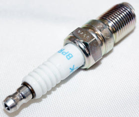 NGK plug installed in an engine spark plug well demonstrating proper fitment and benefit