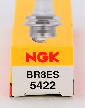 NGK BR8ES beside a coin for size comparison, helps confirm fitment benefit