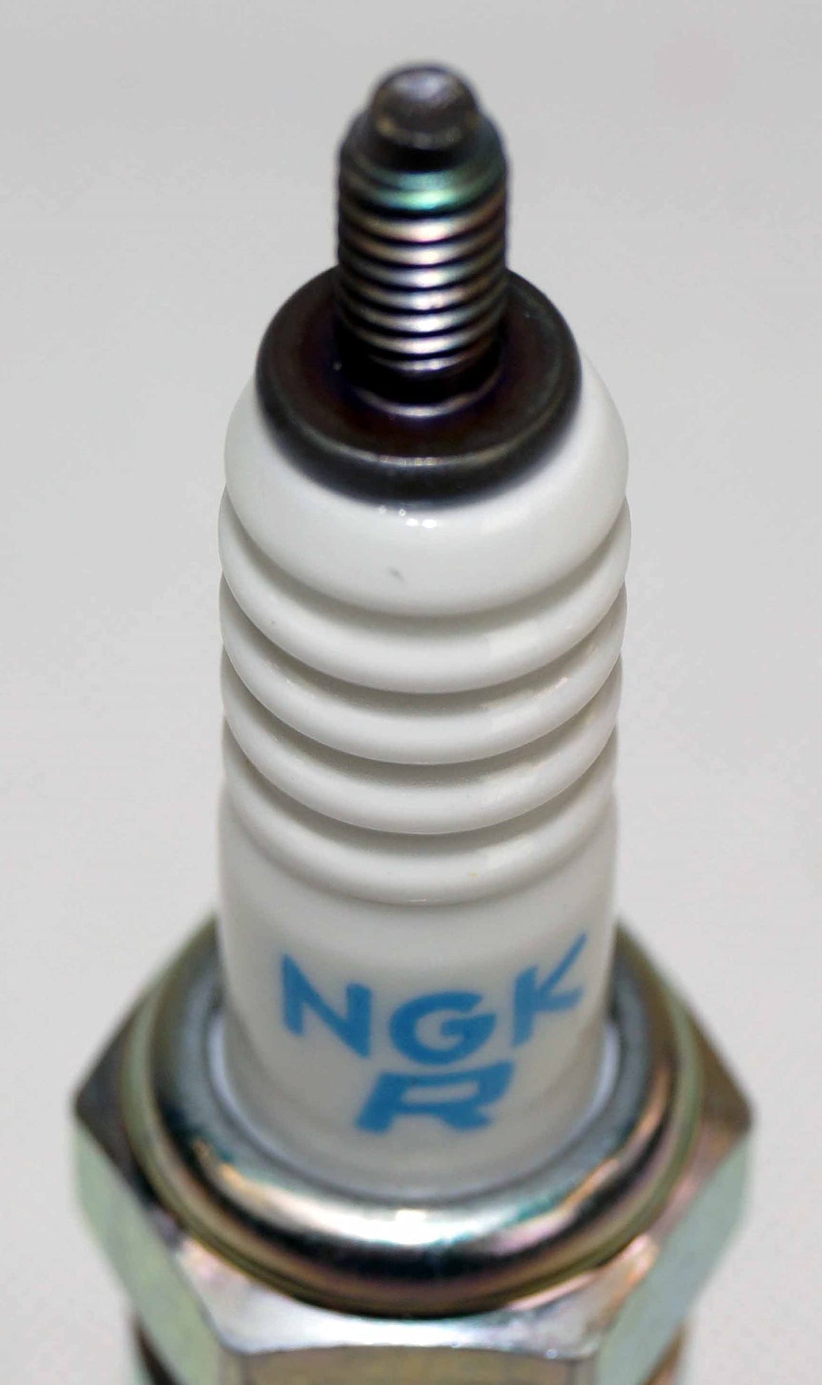 NGK CR7E installed in engine cylinder head demonstrating proper fit and smooth starting benefit