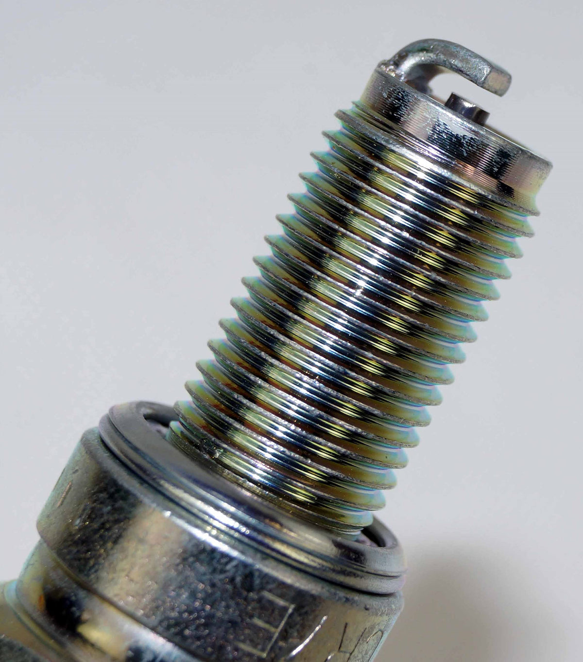 NGK CR7E next to ruler to show thread length and reach for correct fitment confirmation