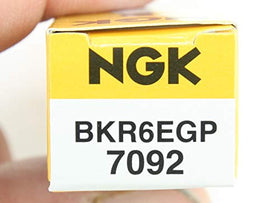 NGK G-Power plugs on a workbench in a garage highlighting ready-to-install convenience