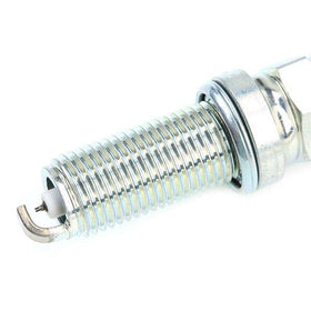 NGK ILKAR7L11 next to ruler showing compact size and thread detail