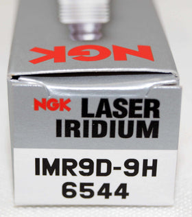 NGK plugs on workbench with tools showing professional installation benefit