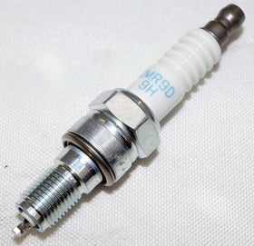 NGK spark plug beside ruler showing size and correct fitment benefit