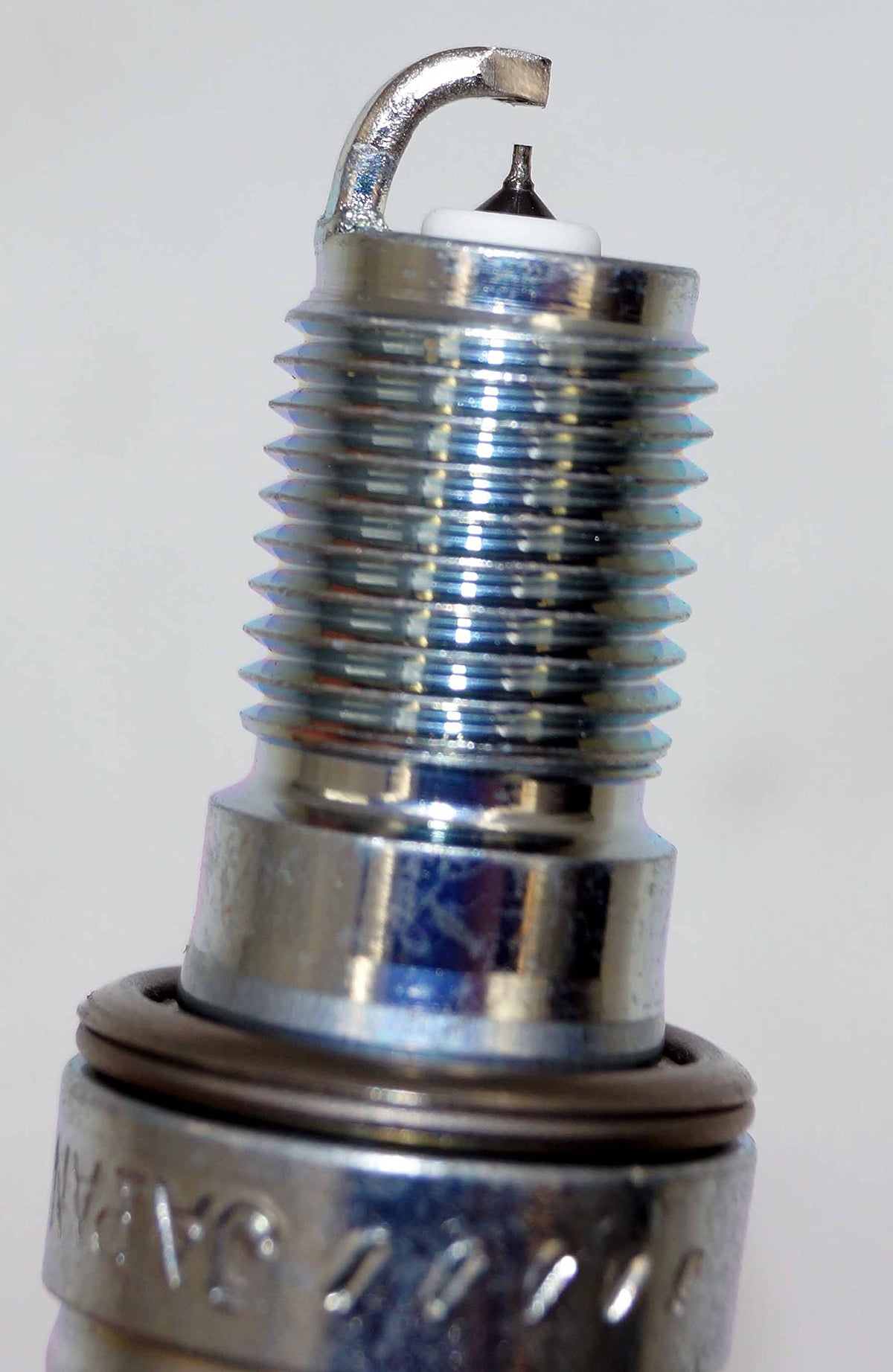 NGK side profile showing threads and sealing surface for leak prevention