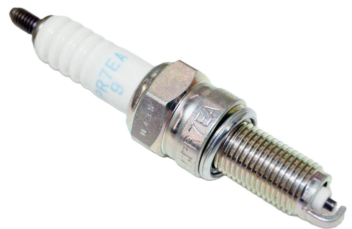 NGK spark plug installed in ATV engine showing compatibility and straightforward replacement