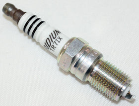 NGK plug beside a ruler illustrating compact size for simple fit and accurate replacement