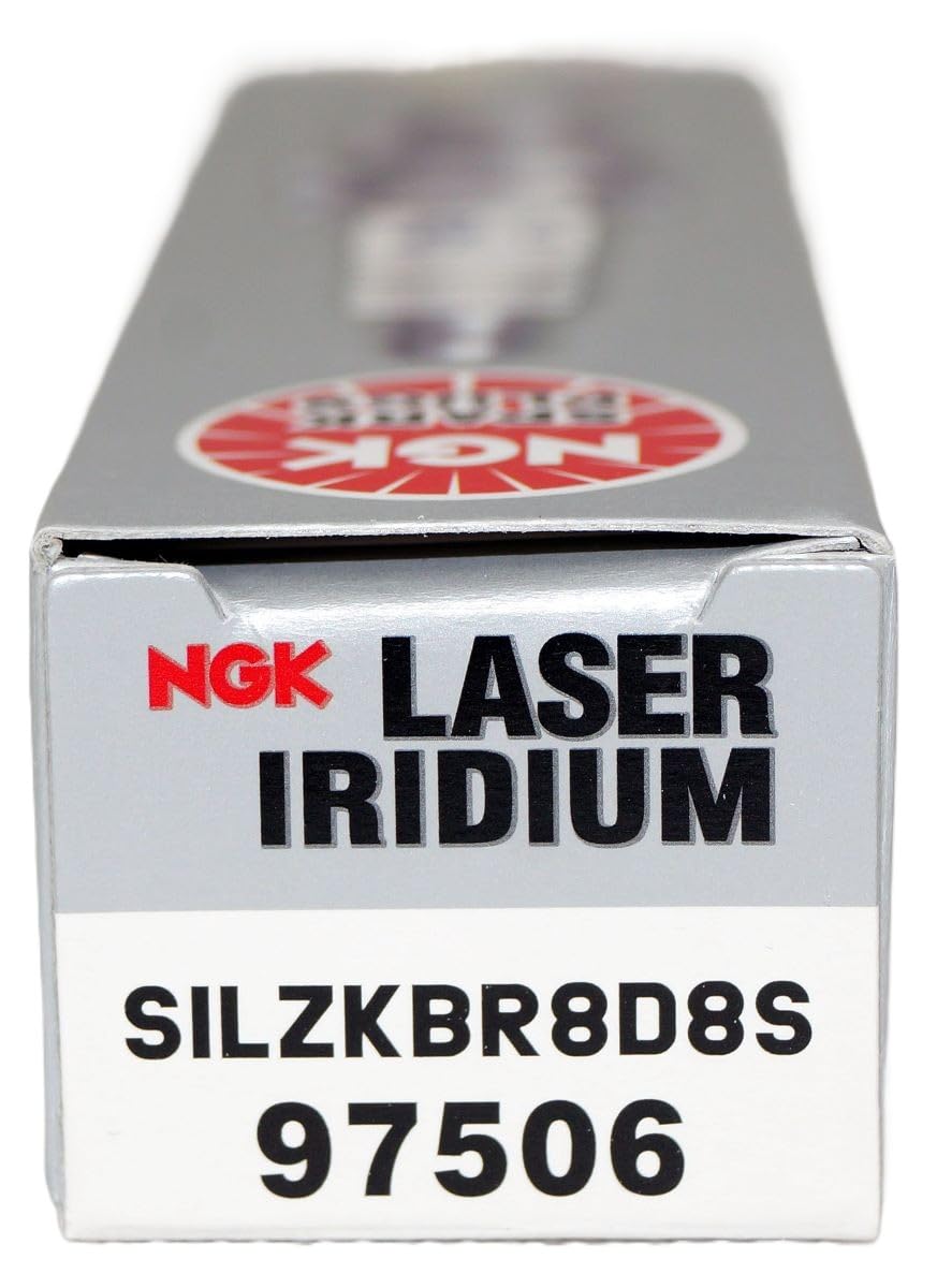 NGK spark plug beside car keys representing preparedness for reliable driving