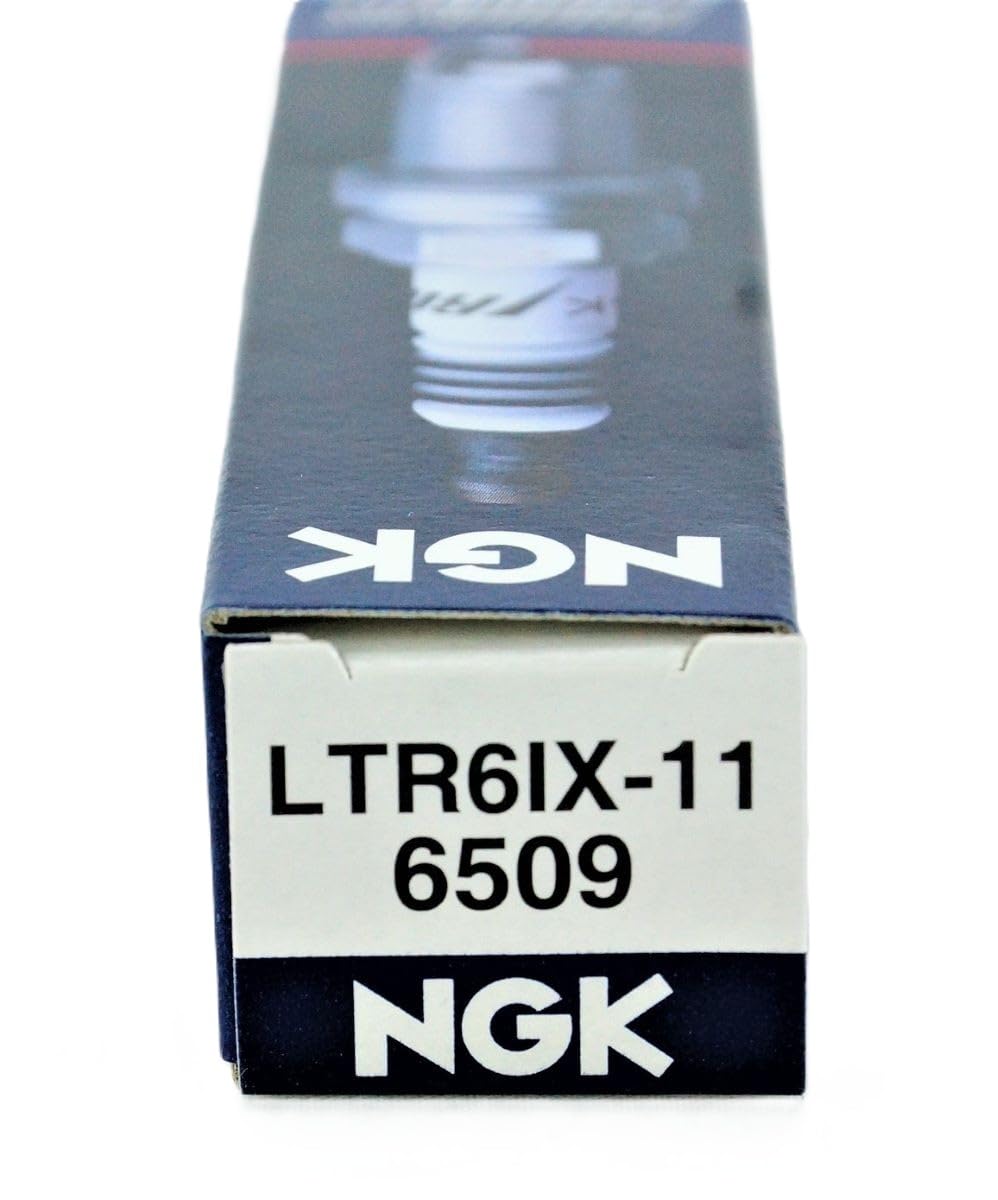 NGK LTR6IX-11 on a workbench during installation showing practical maintenance advantage