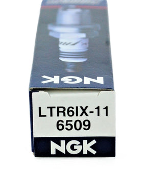 NGK LTR6IX-11 on a workbench during installation showing practical maintenance advantage