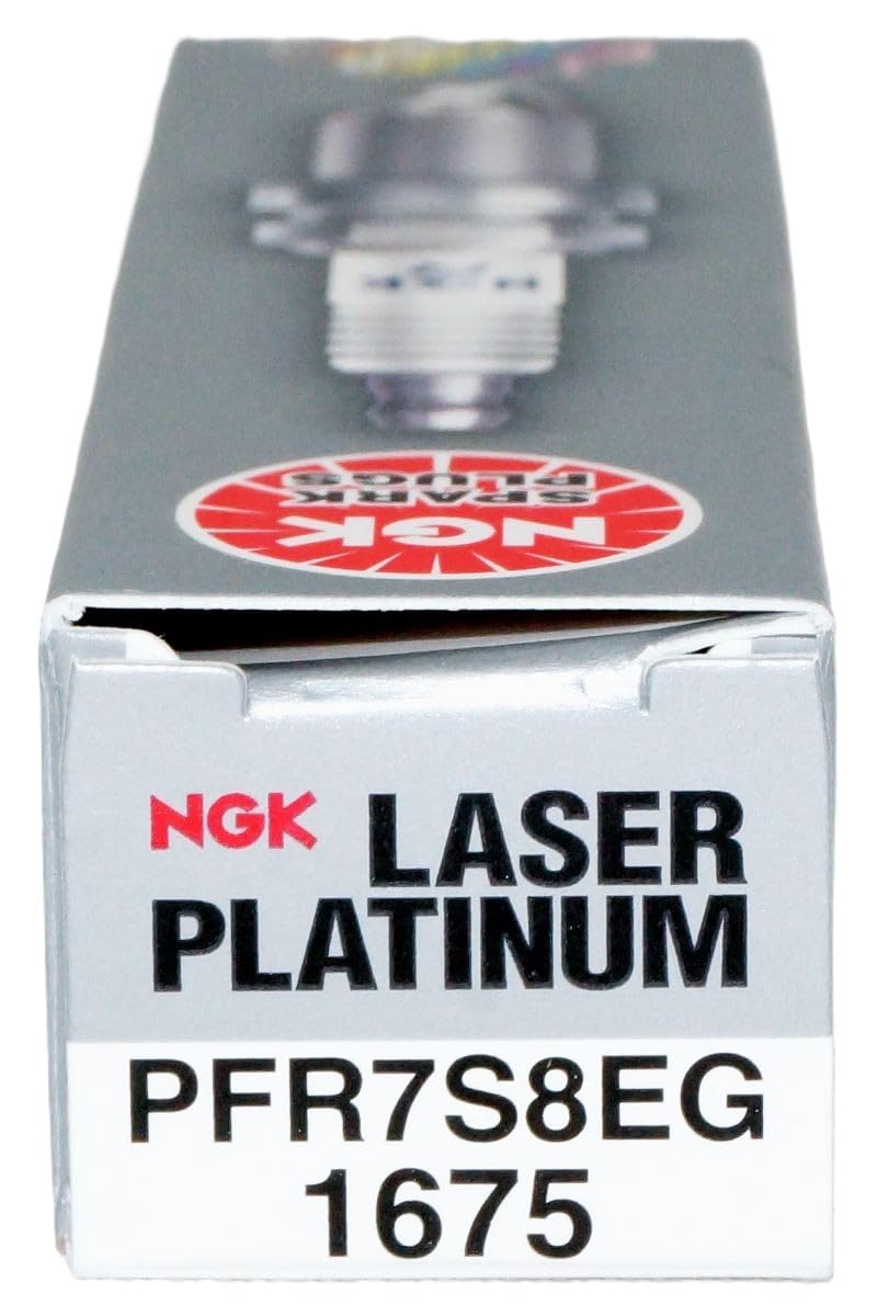 NGK spark plugs on workbench in garage showcasing maintenance readiness