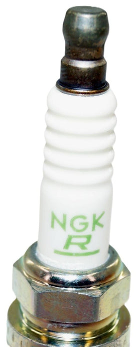 Hand holding NGK spark plug to show scale and easy handling during install