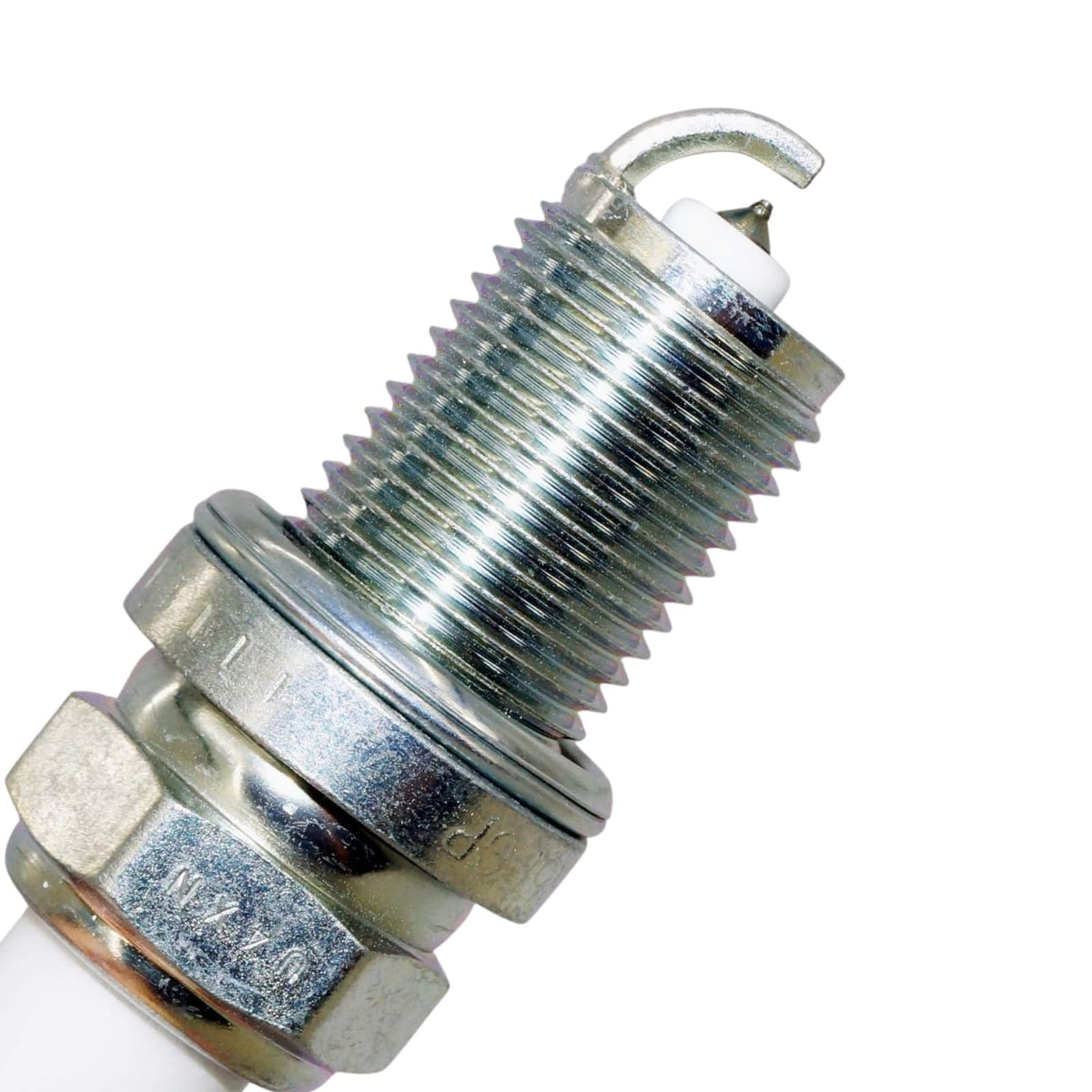 NGK spark plug beside ruler for scale showing size and fitment clarity