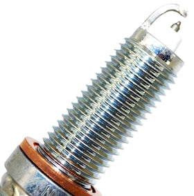 NGK spark plug installed in BMW engine bay demonstrating OEM-fit reliability