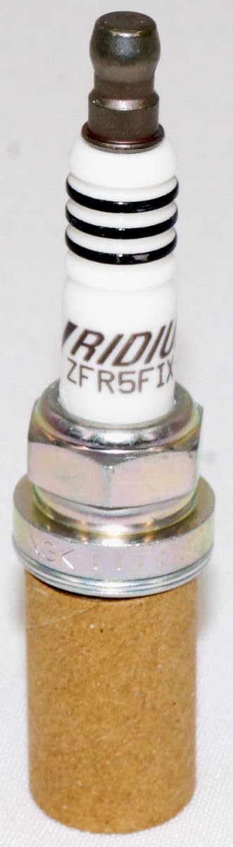 NGK spark plug in hand for scale showing compact OEM fit advantage