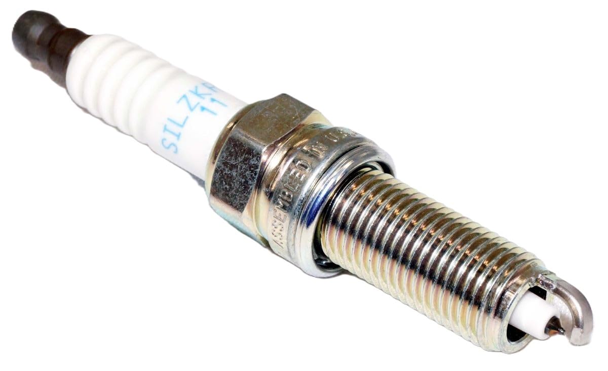 NGK plug held in hand showing scale and ease of handling during service