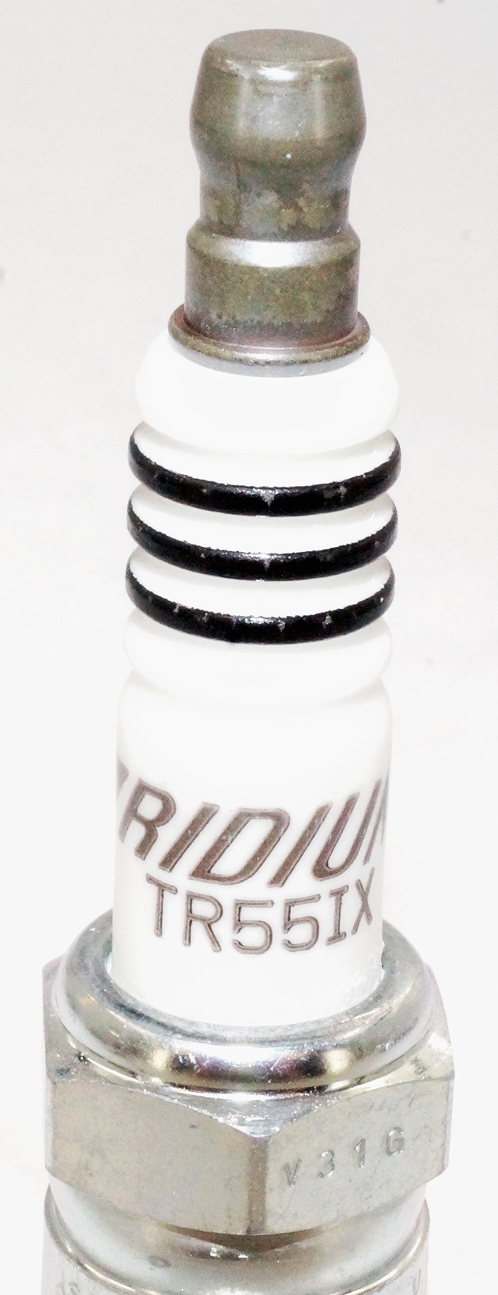 Six NGK TR55IX plugs arranged on table demonstrating complete 6-pack convenience