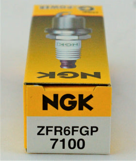 NGK spark plug beside ruler showing scale for accurate sizing and fit confirmation