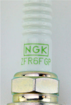NGK spark plug being installed with a socket highlighting correct use and safety