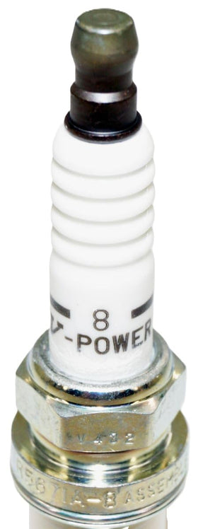 NGK spark plugs in hand for scale showing eight-pack quantity and straightforward home-install benefit