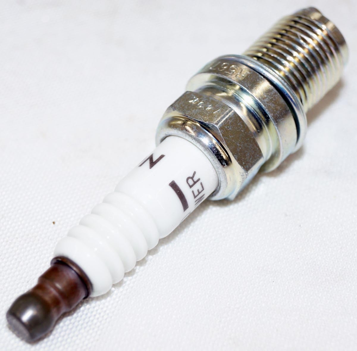 NGK V-Power plugs in hand scale to show size and quick identification benefit