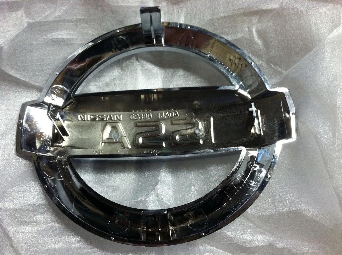 NISSAN emblem close-up of plastic chrome finish highlighting accurate factory look