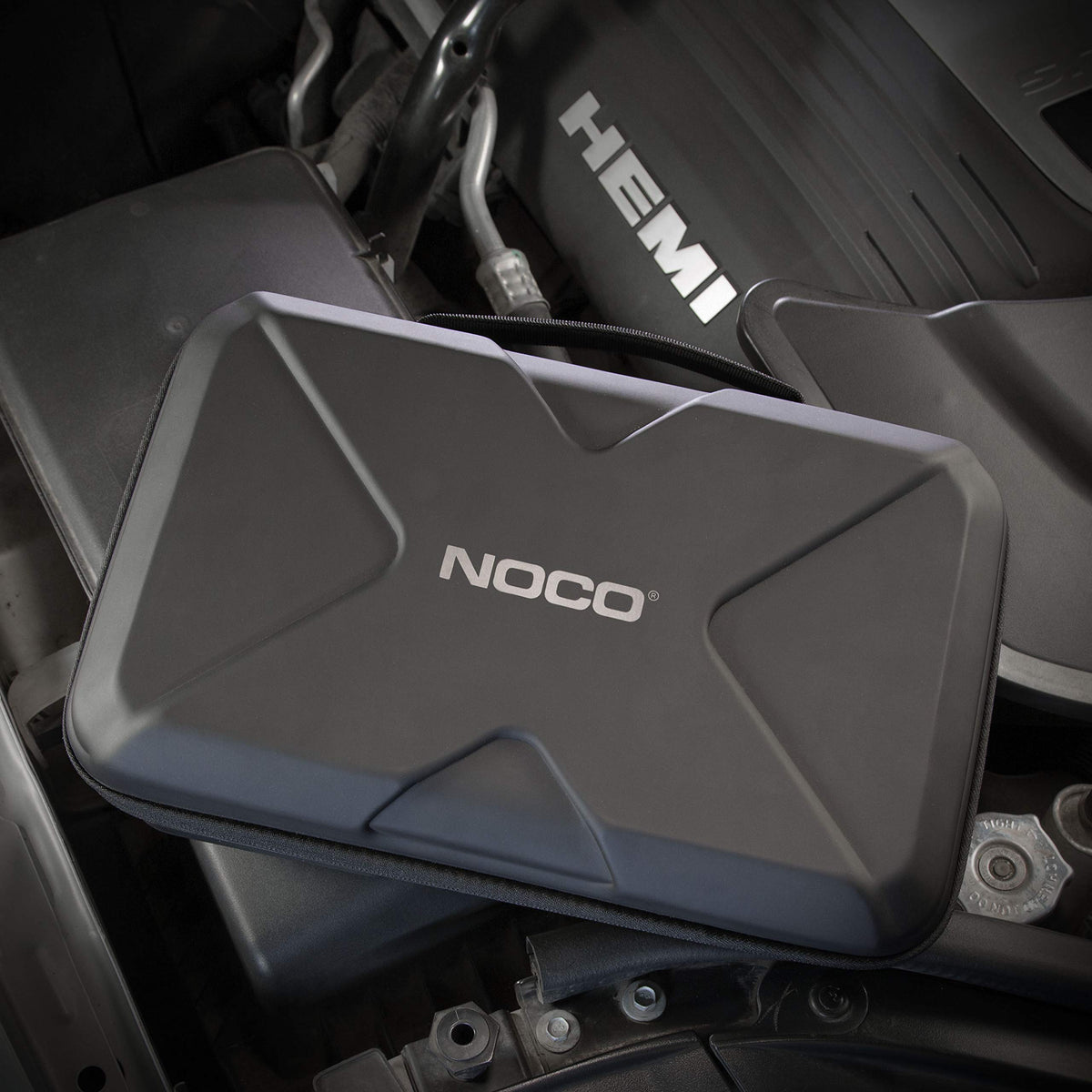 NOCO case shown in hand to demonstrate compact, glovebox-ready size