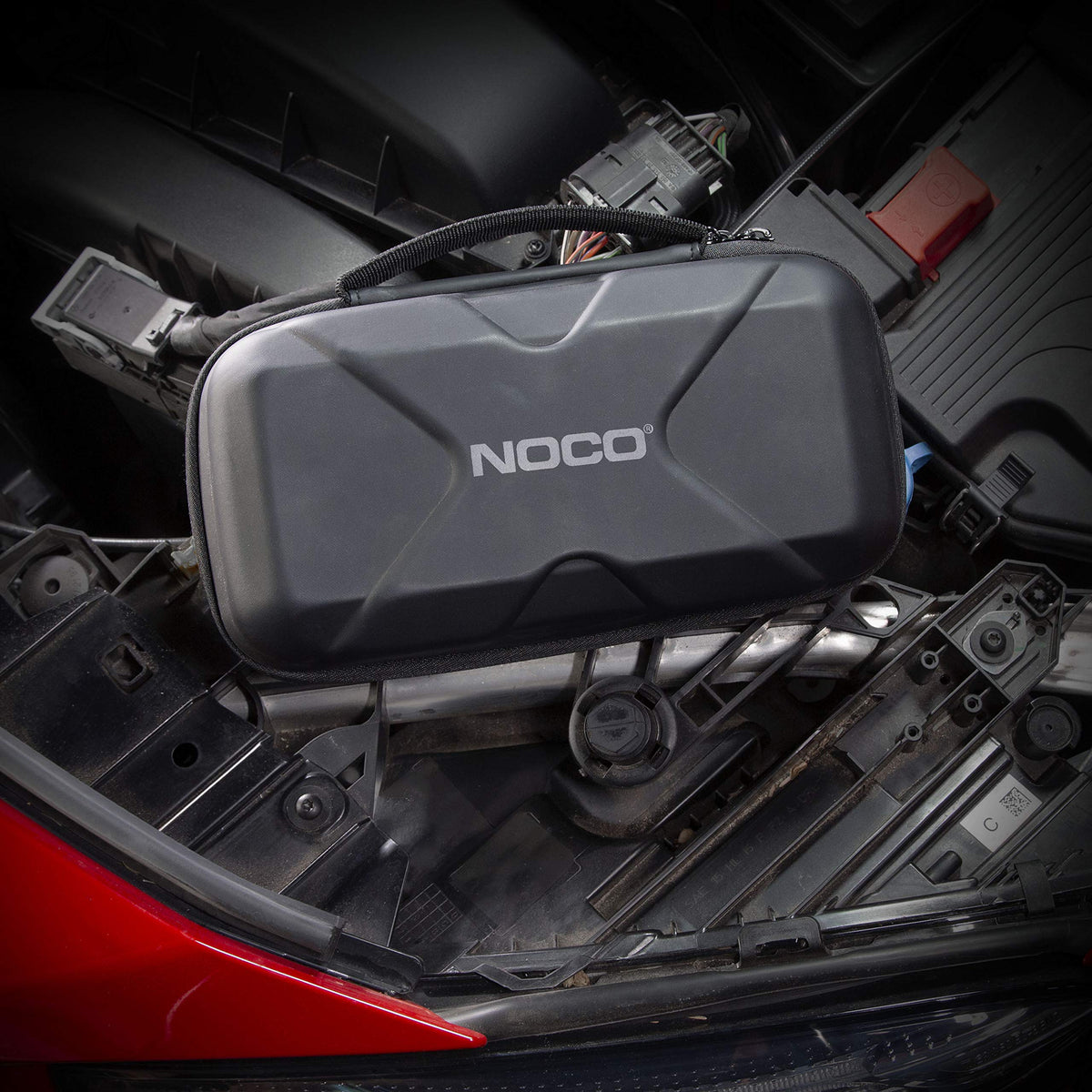 NOCO Boost XL case fitting inside a vehicle glovebox for space-saving storage