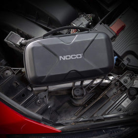 NOCO Boost XL case fitting inside a vehicle glovebox for space-saving storage