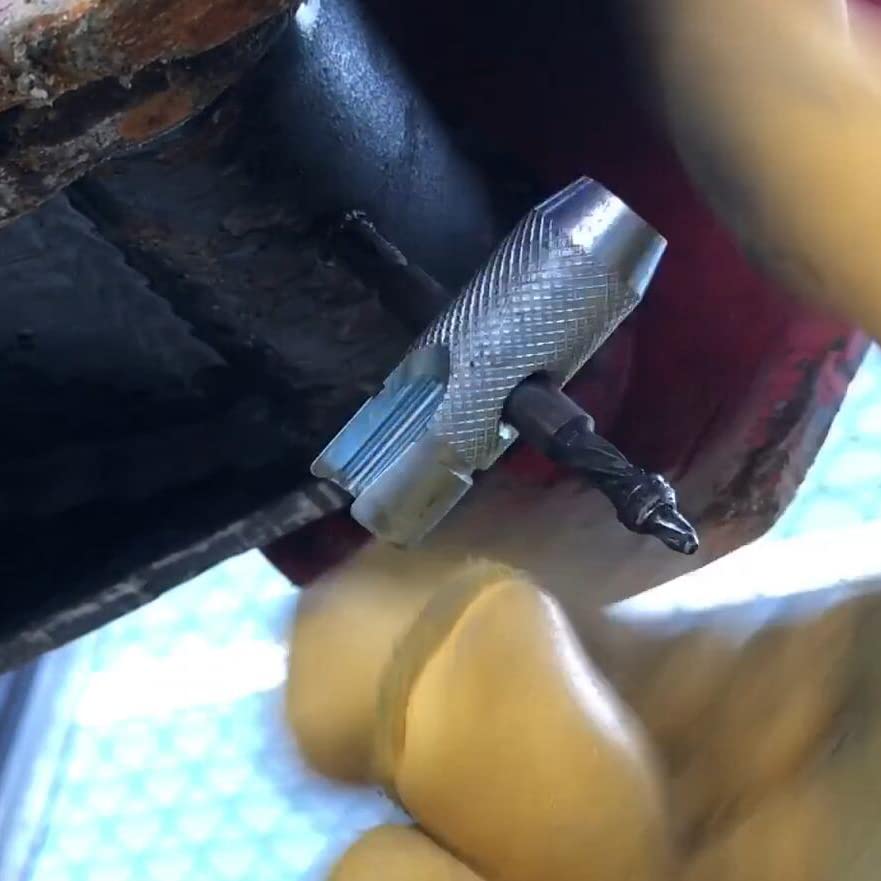 NOVINO cross tool next to a wrench for scale showing compact size and portability benefits