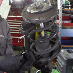 OEMTOOLS kit on garage workbench beside tools, showing practical workshop use and portability