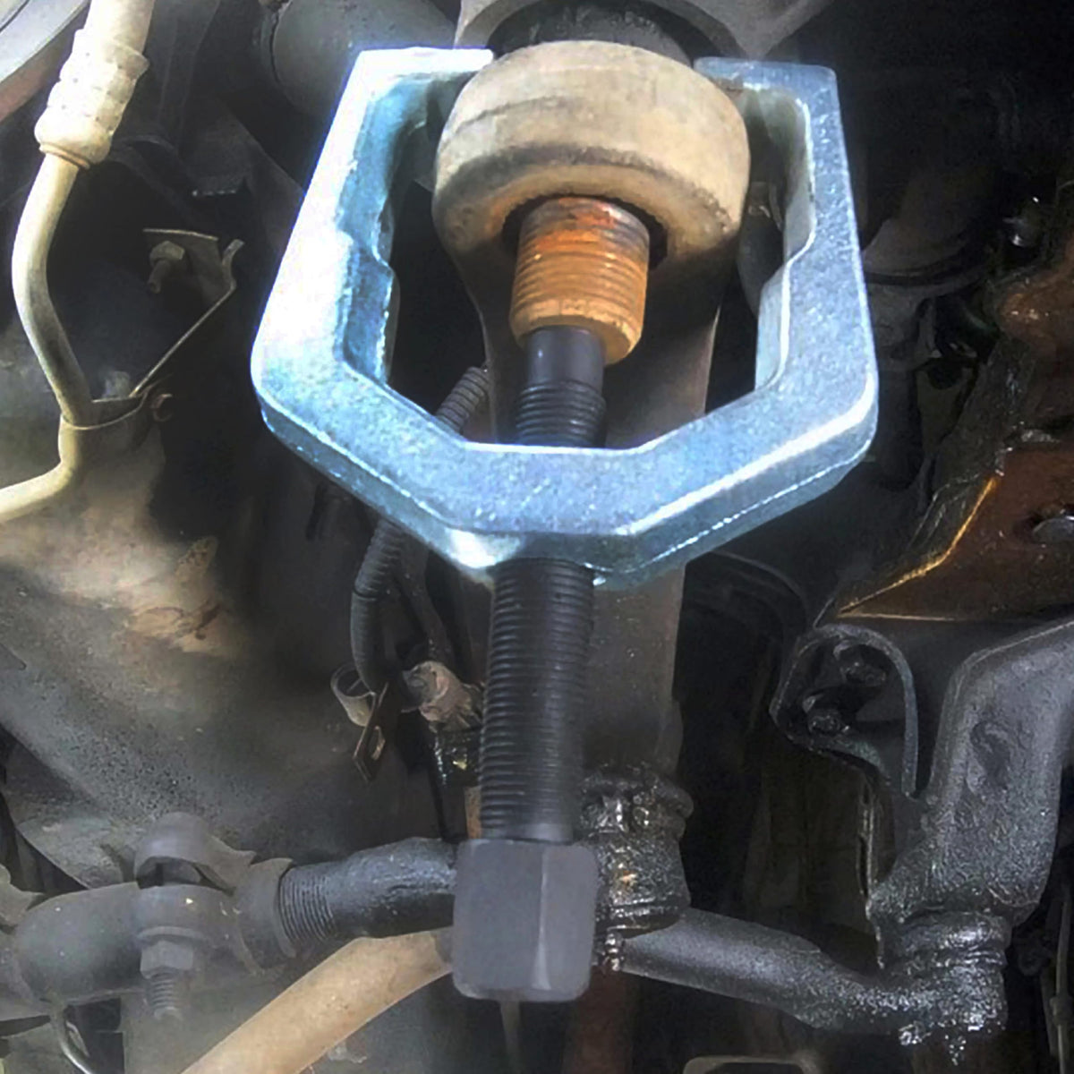 OEMTOOLS pitman arm puller in a garage setting for professional repairs