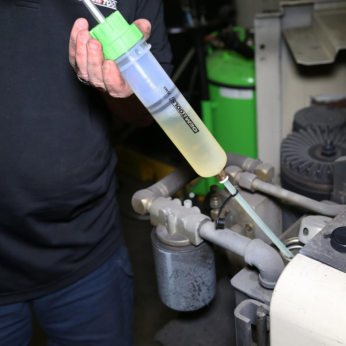 OEMTOOLS pump next to ruler showing compact size for toolbox portability