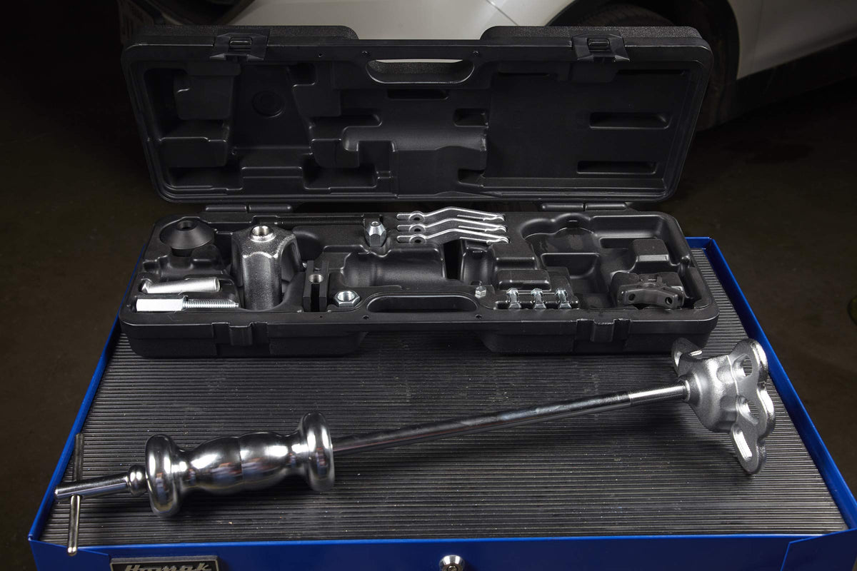 Mechanic using OTC kit on a hub illustrating faster, safer pulls